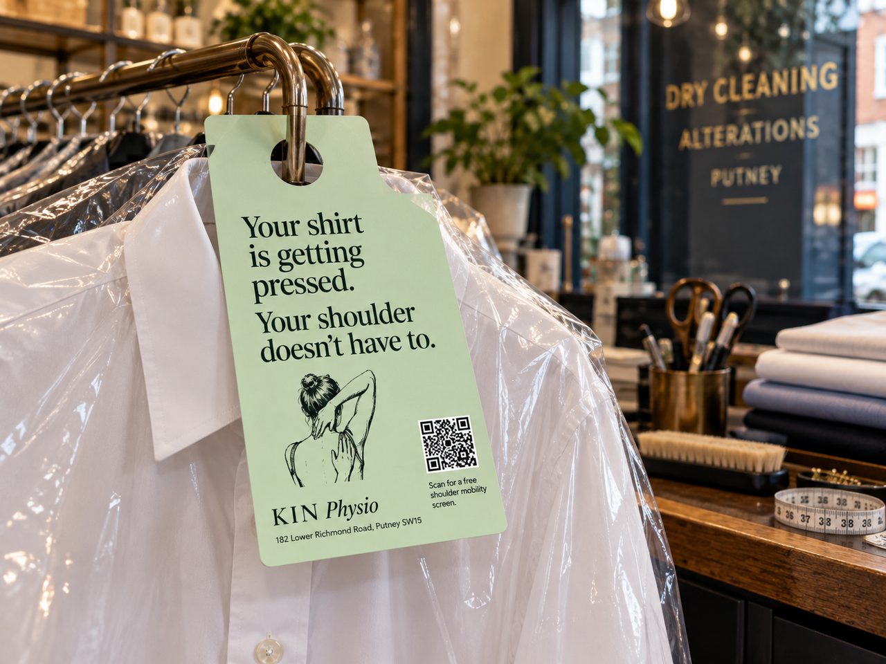 KIN Physio hanger tag inside a dry cleaner